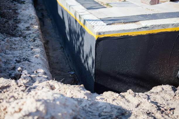Professional Basement Waterproofing technician working in Danville, VA